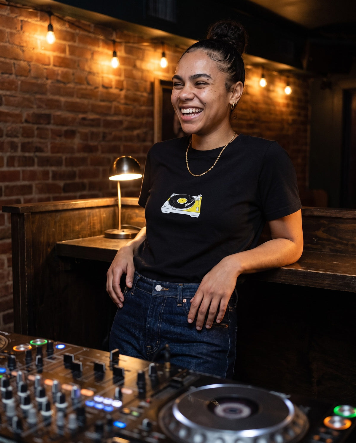 Model wearing the Spin That t-shirt in Black, behind a DJ booth