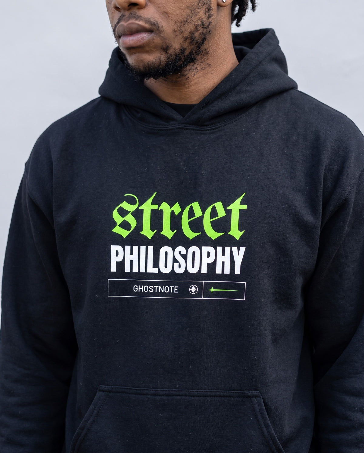 Model wearing the Street Philosophy Hoodie Embroidered in Black, print close-up