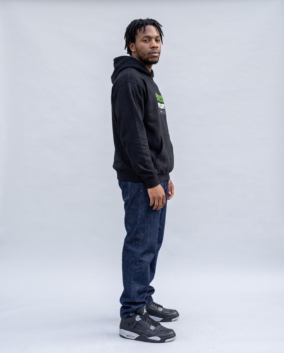 Model wearing the Street Philosophy Hoodie Embroidered in Black, side profile