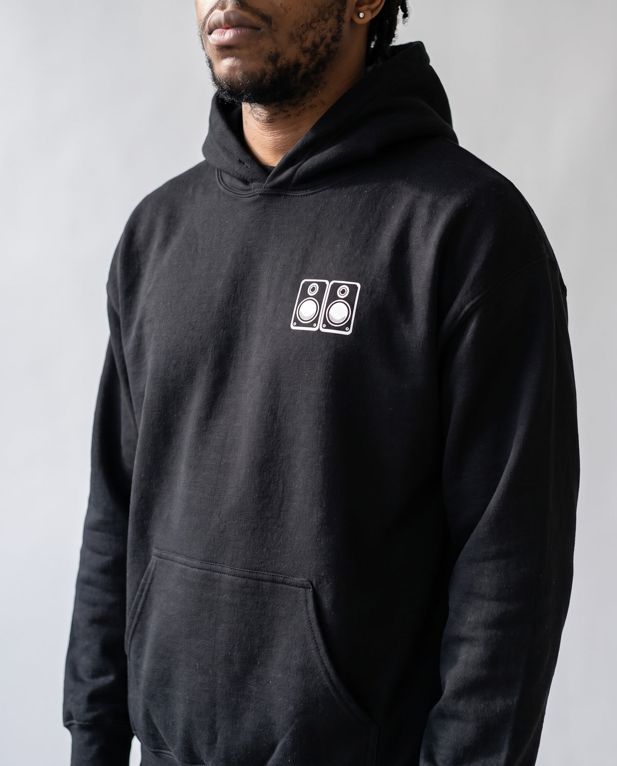 Model wearing the Studio Monitors hoodie in Black, print close-up