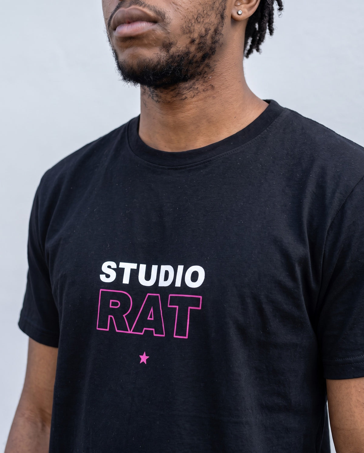 Model wearing the Studio Rat t-shirt in Black, print close-up