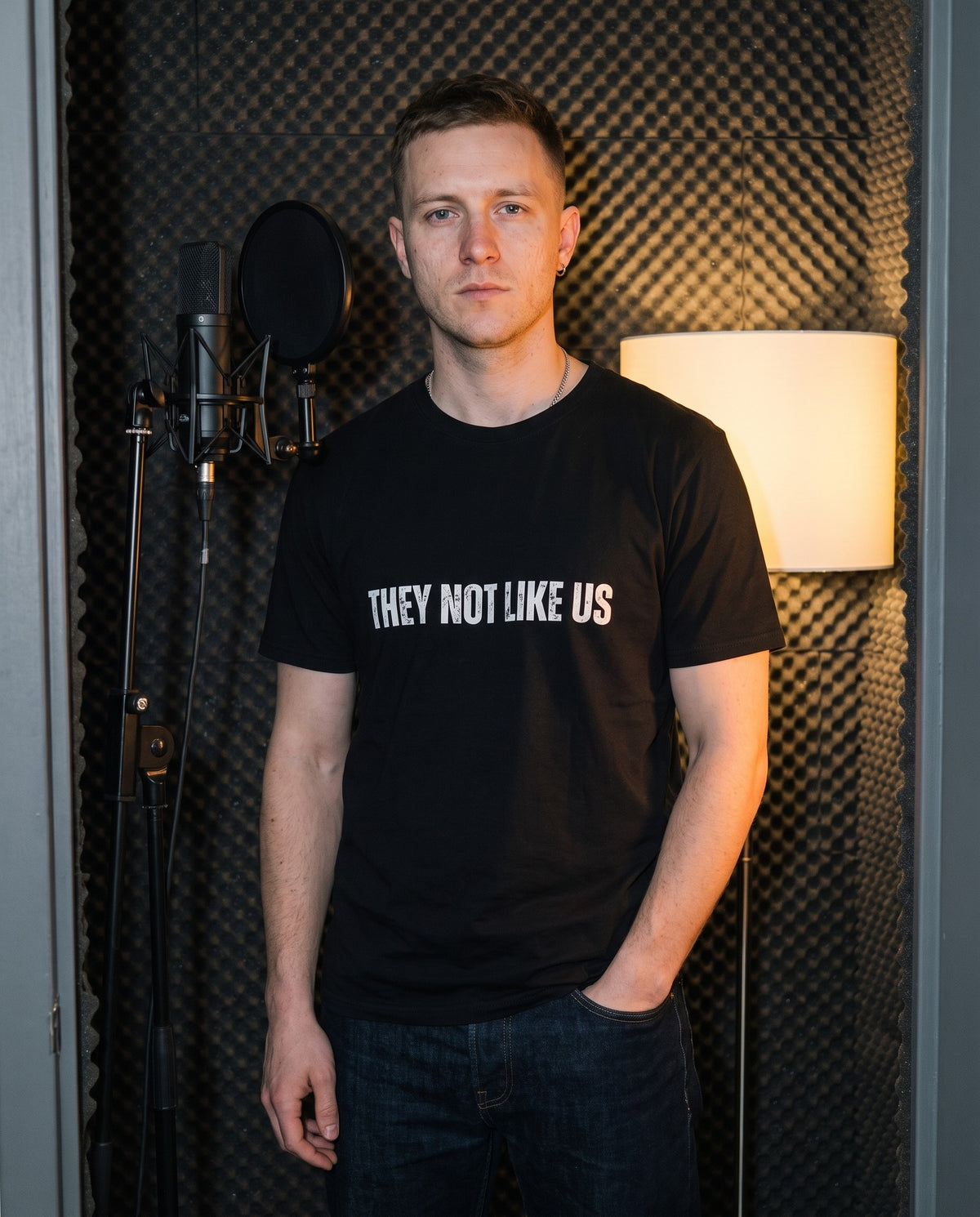 Model wearing the They Not Like Us t-shirt in Black, in a vocal booth