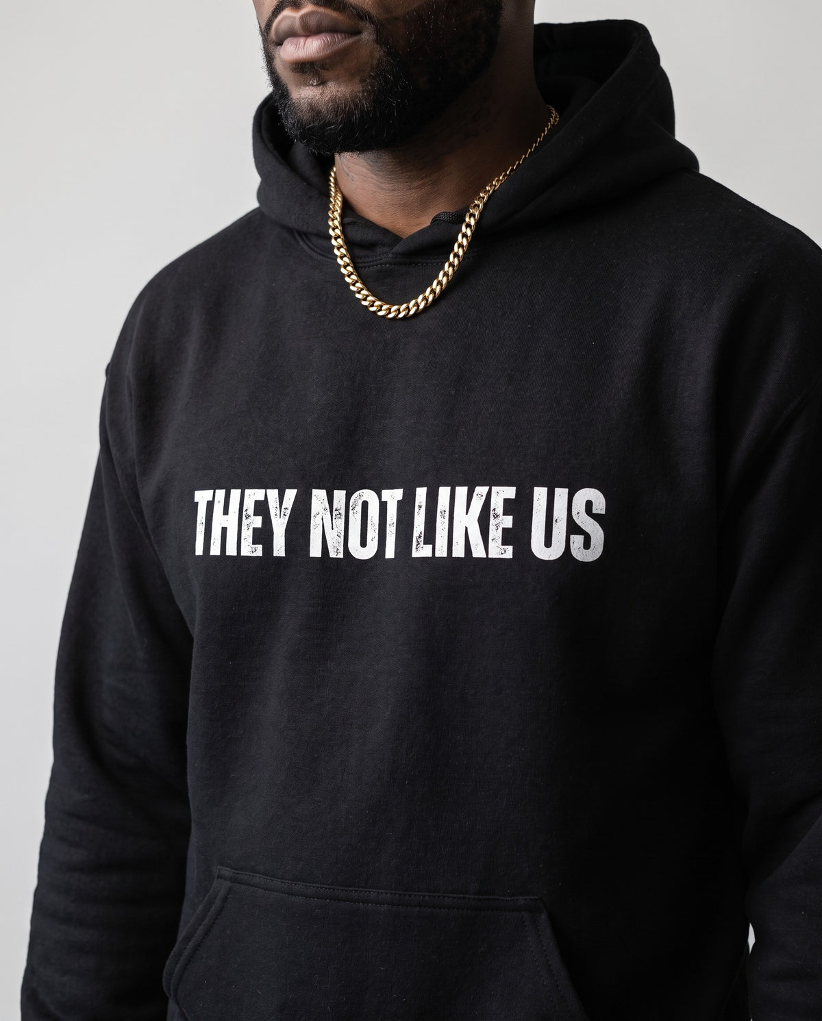 Model wearing the They Not Like Us Rapper Hoodie in Black, print close-up