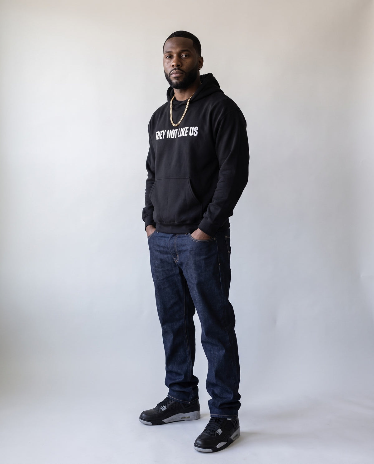 Model wearing the They Not Like Us Rapper Hoodie in Black, full length