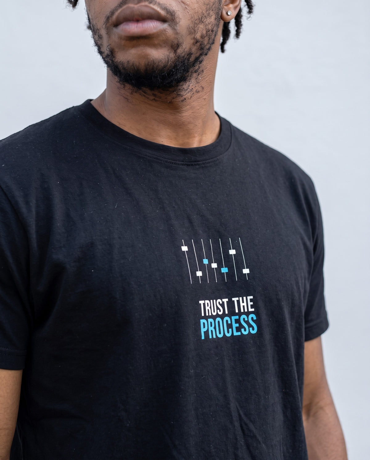 Model wearing the Trust The Process t-shirt in Black, print close-up