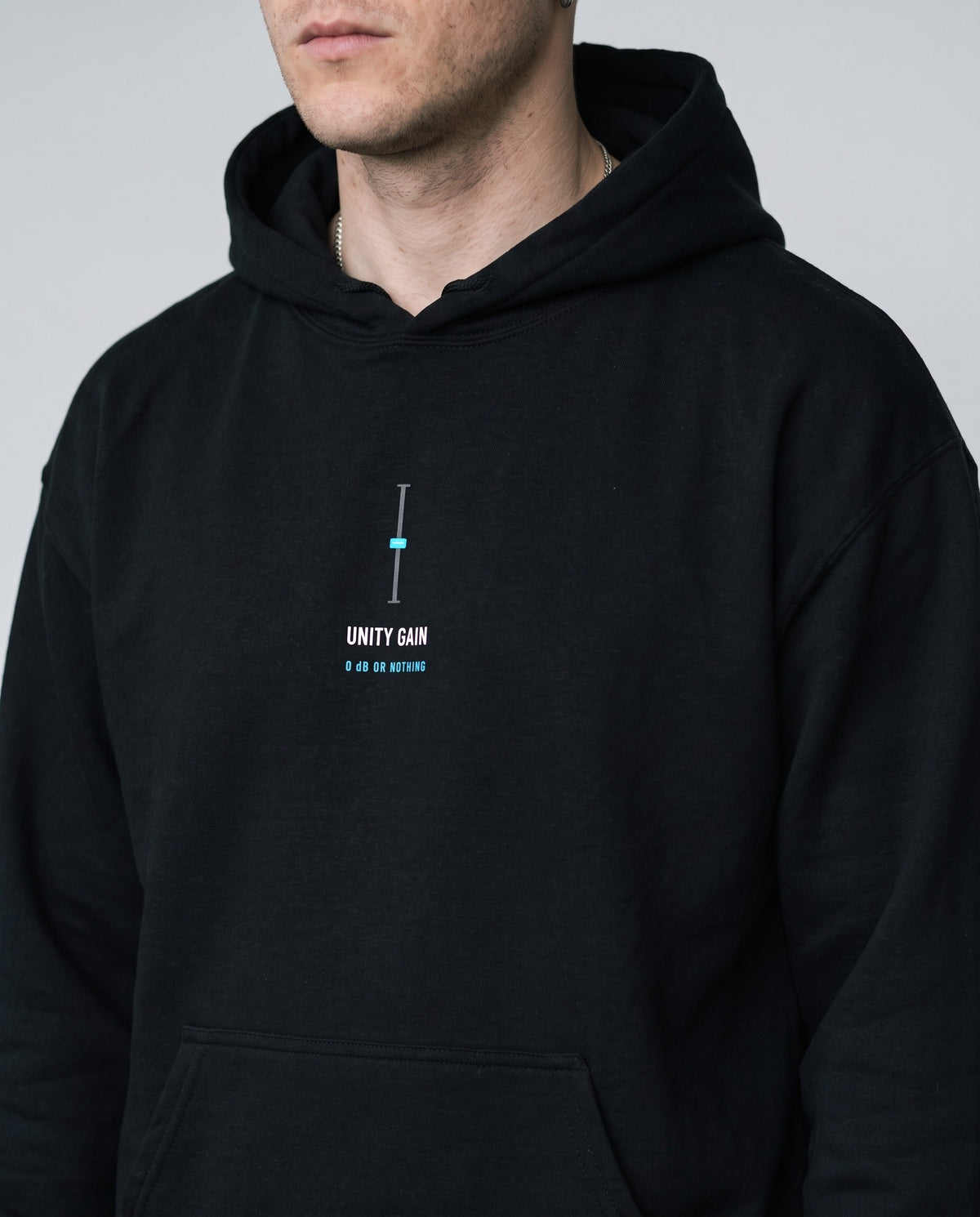 Model wearing the Unity Gain hoodie in Black, print close-up