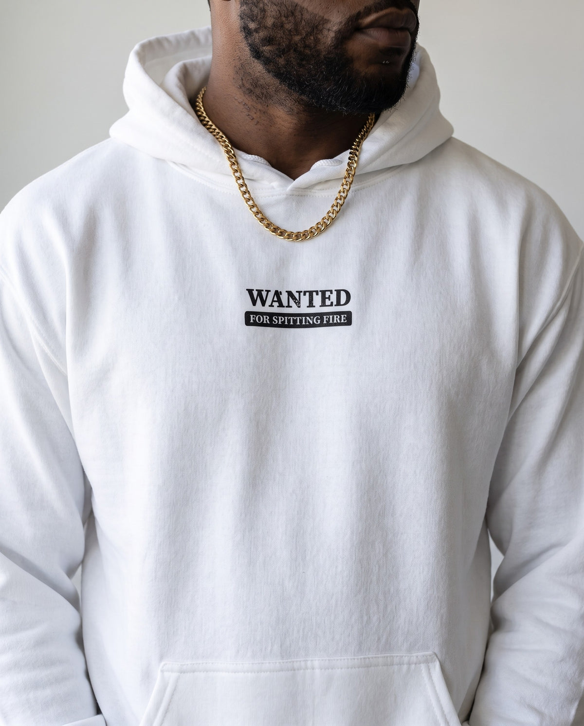 Model wearing the Wanted For Spitting Fire hoodie in White, print close-up
