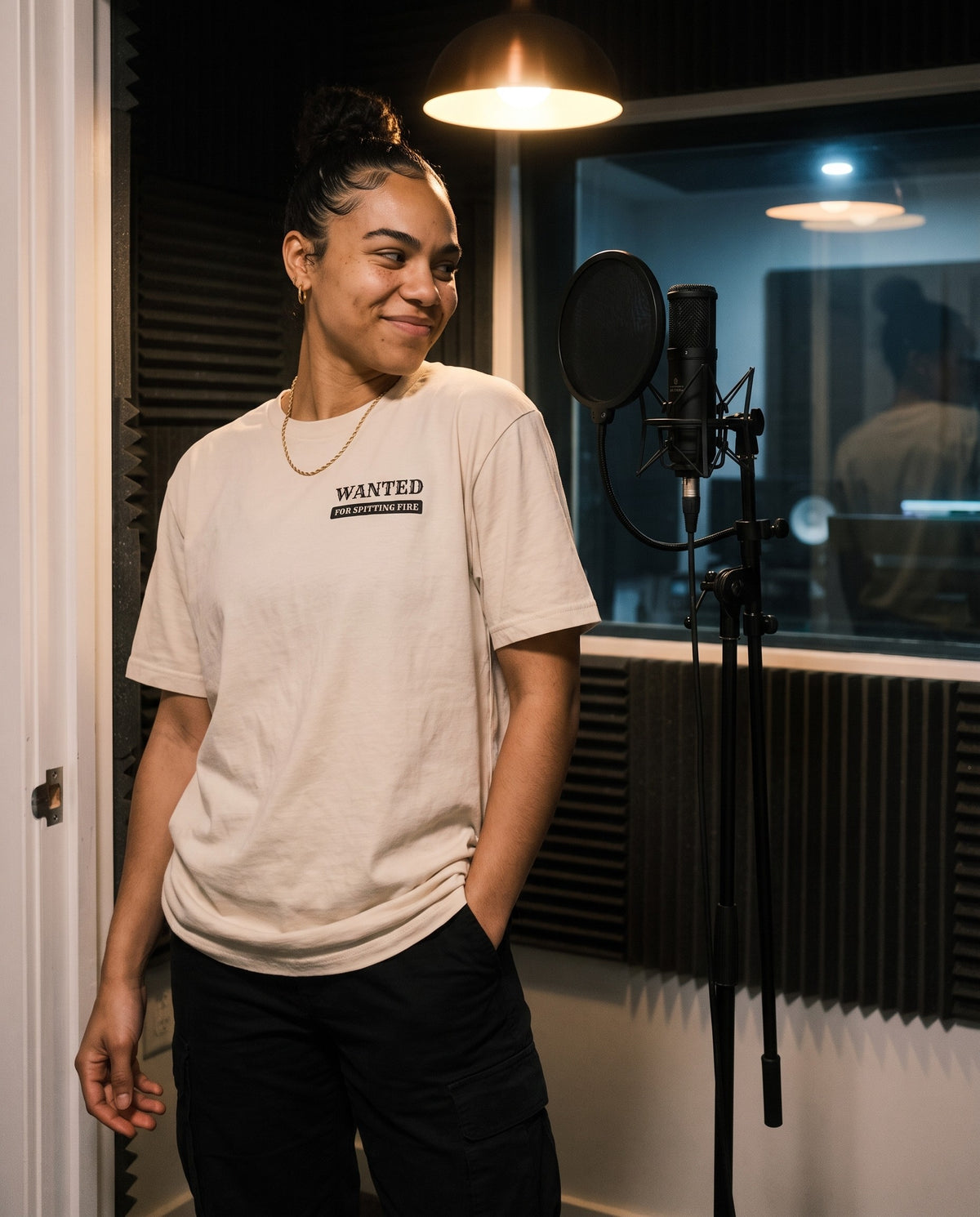 Model wearing the Wanted For Spitting Fire t-shirt in Beige, in a vocal booth