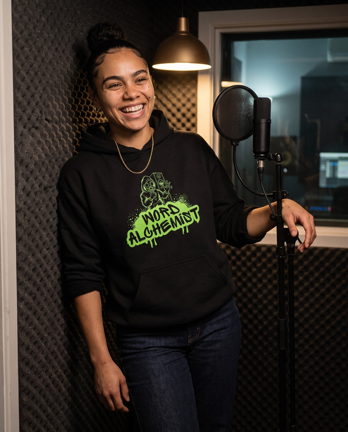 Model wearing the Word Alchemist hoodie in Black, in a vocal booth